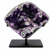 Amethyst geode on black metal stand